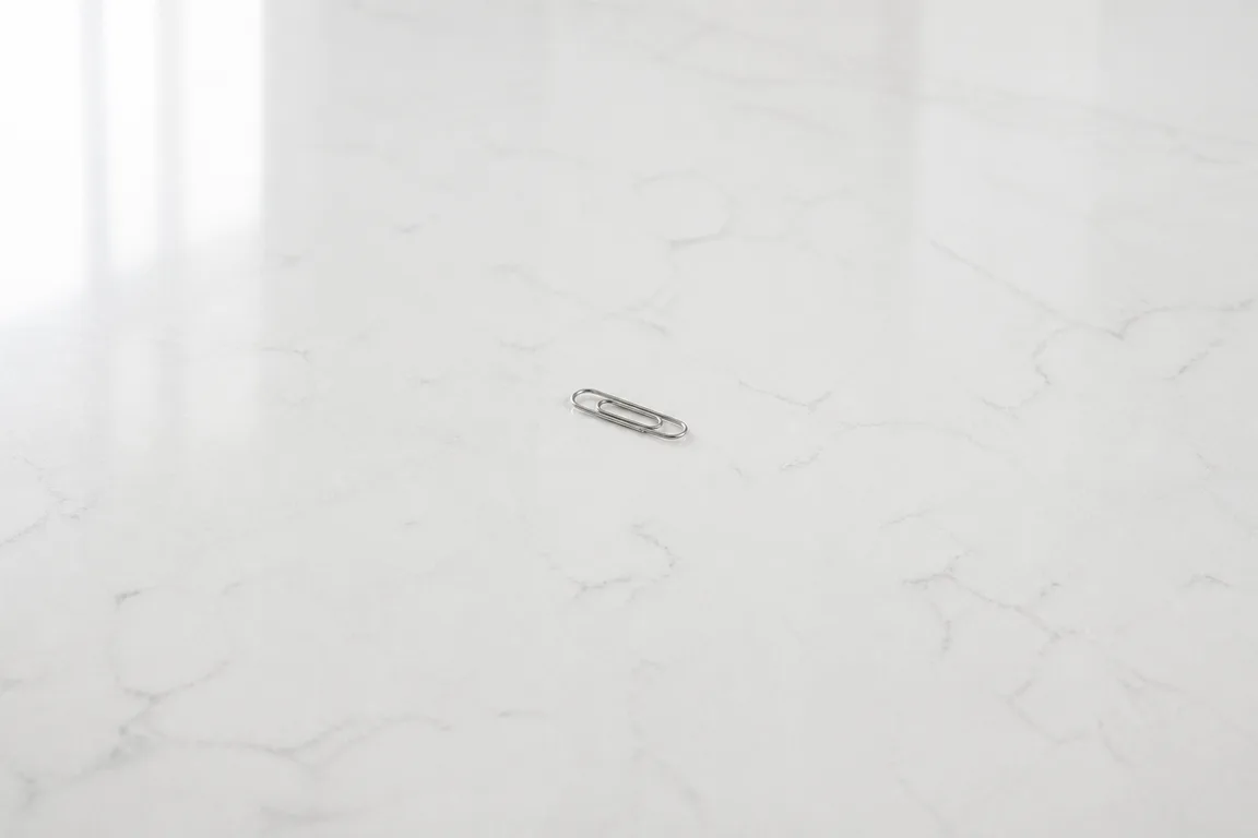 Single paperclip on a white marble counter